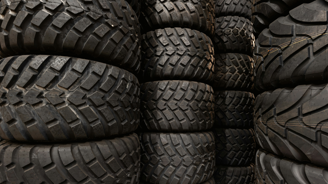 Stacked off-road tyres with deep tread patterns, representing high-performance and durable tyre options from mytyres.co.uk by Delticom