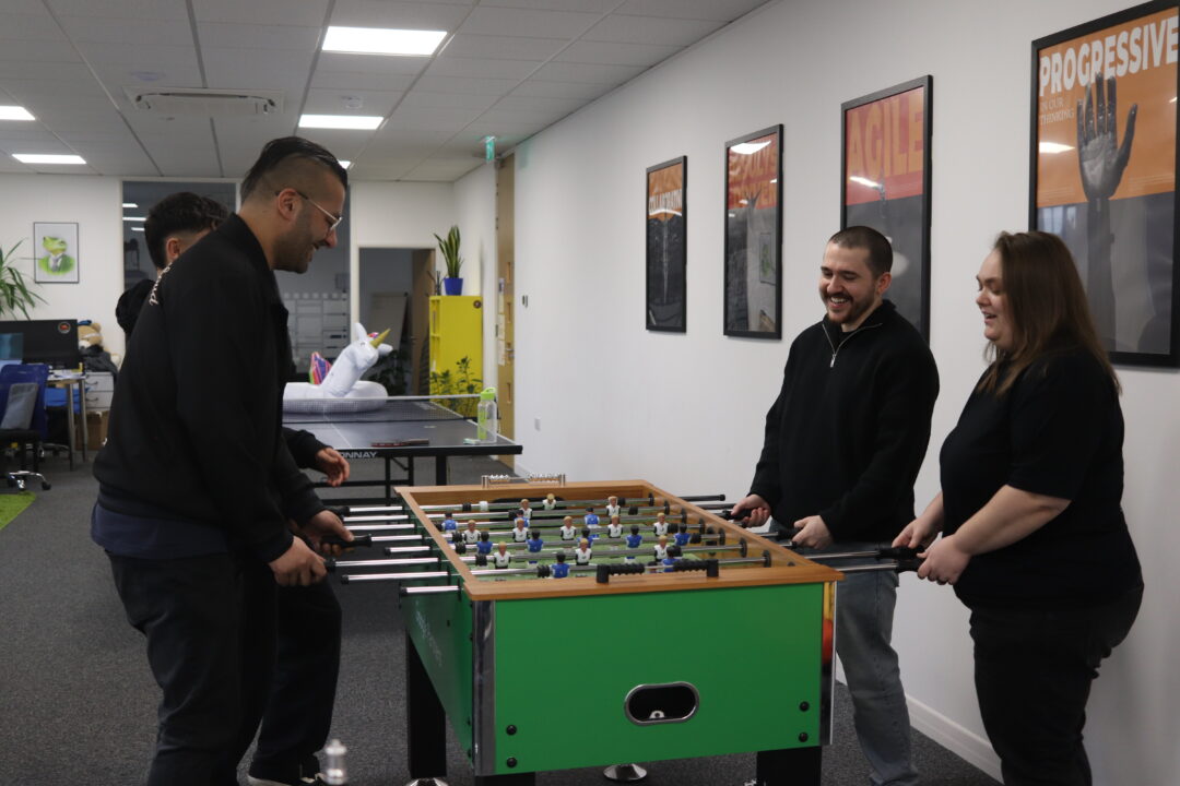 Repeat Digital team members enjoying a game of table football in the office breakout area