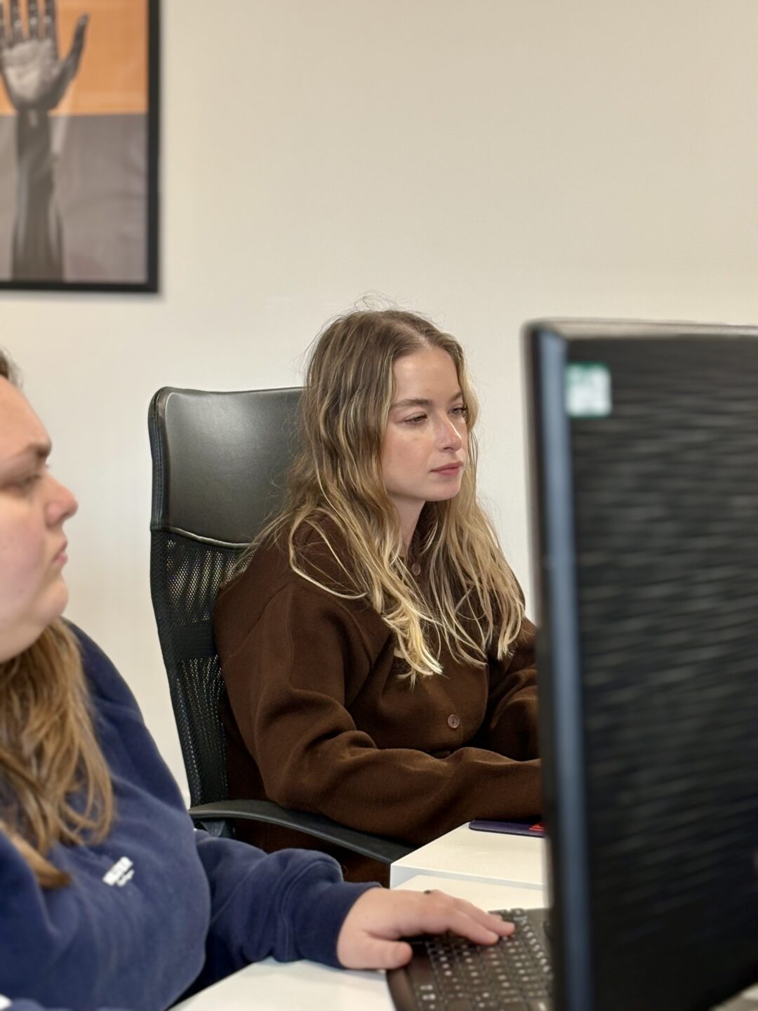 Two team members working at their desks in the Repeat Digital office