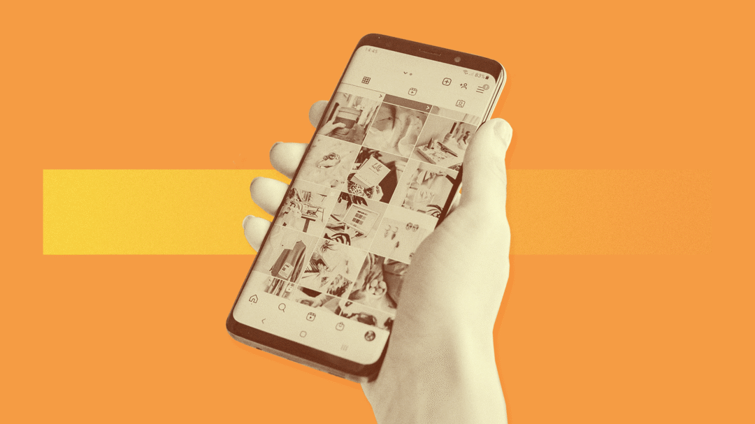 hand holding a smartphone with Instagram on the screen