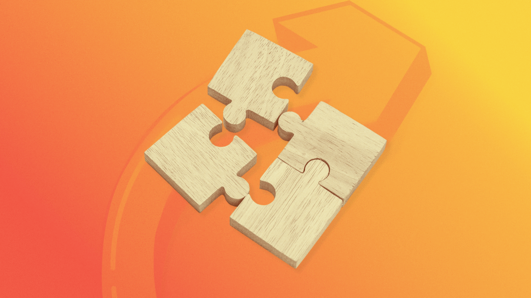 Wooden puzzle pieces connecting on orange background representing integrated digital marketing strategy