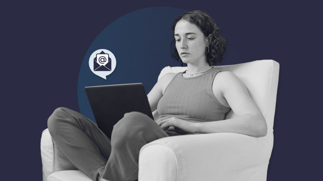 Person sitting on a chair working on a laptop, with an email icon graphic beside them on a dark blue background